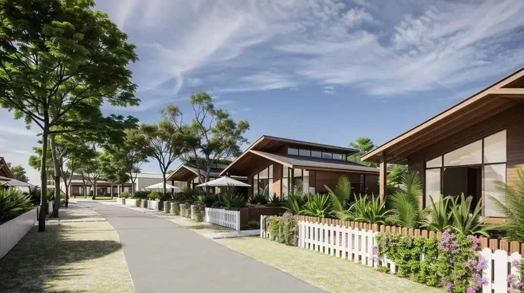 Timber garden chalets behind white fences along a path, Doris Mataking Resort